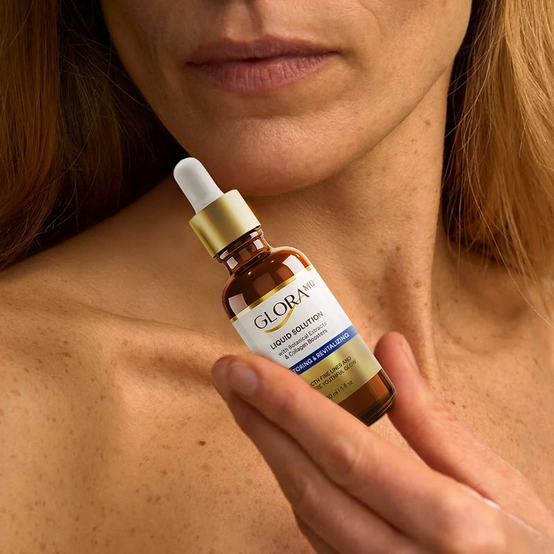 Seller image of a woman holding the GloraMD serum bottle